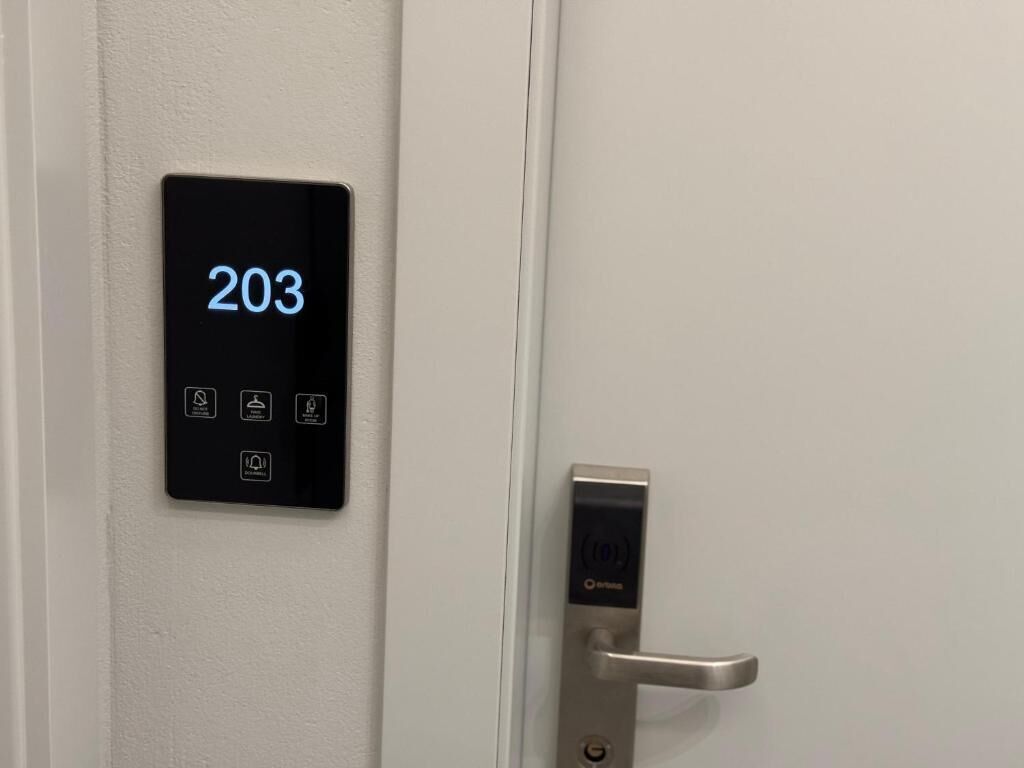 A digital lock with a display showing the number 203 and a keyhole.