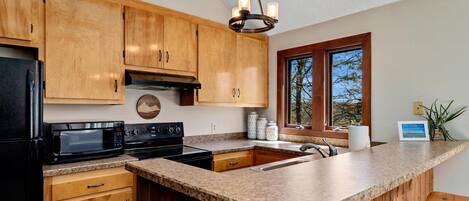 Fridge, microwave, coffee/tea maker, cookware/dishes/utensils