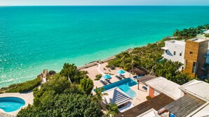 A resort with a swimming pool, beach area, and ocean view. - Villa La Percha With 4 Bedrooms and 4 5 Bathrooms (Providenciales)