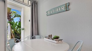 A round table with chairs, a sign reading "BEACH HOUSE", and a plant on the table. - The Beach! | Pool, Hot Tub, Gym, Game Room, Tennis (Ruskin)