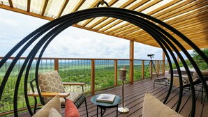 Un espacio de estar al aire libre cubierto con vistas al paisaje.