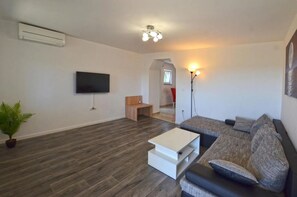 Apartment, Balcony, Sea View | Living area | 80-cm flat-screen TV with satellite channels