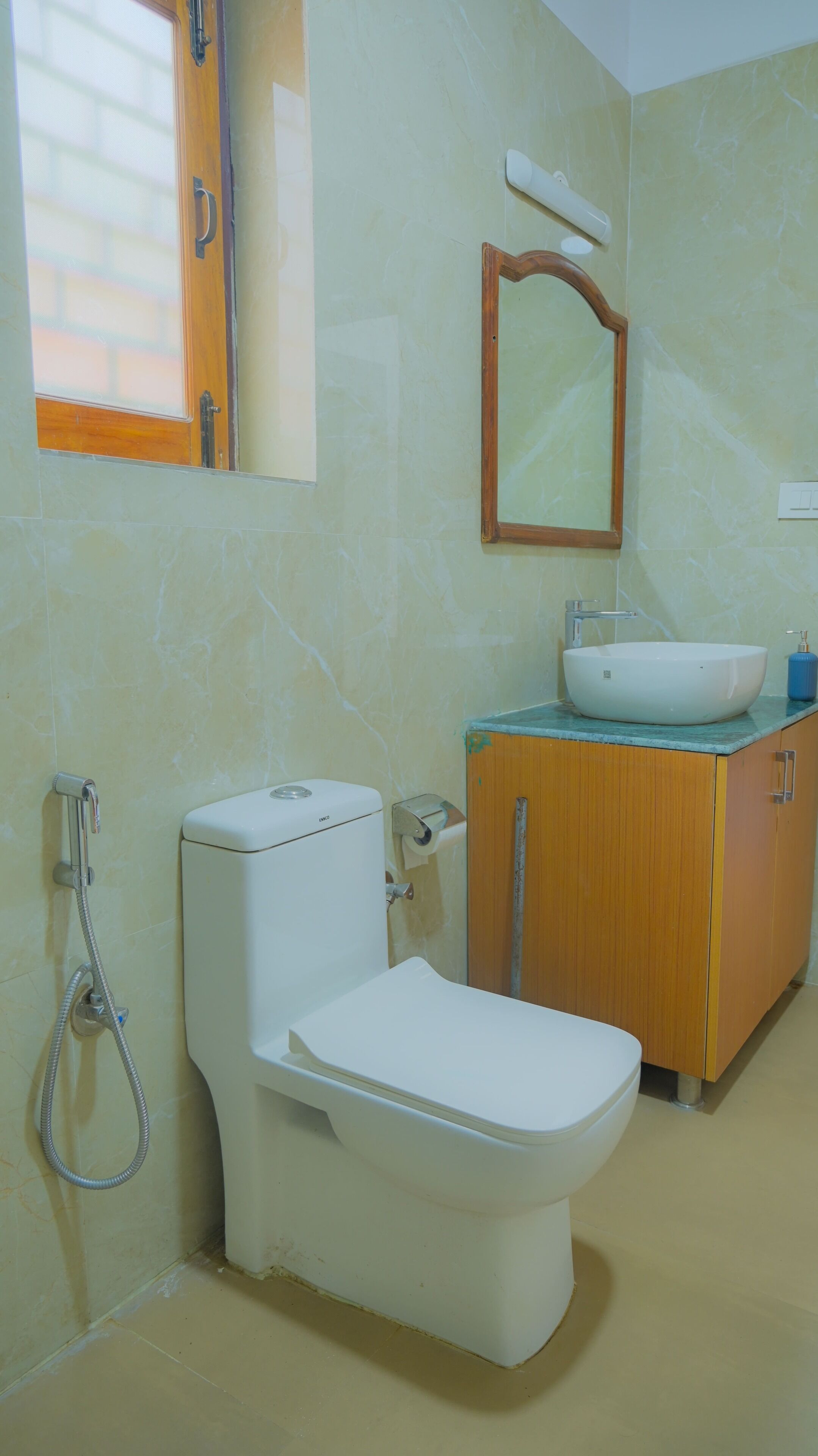 A bathroom with a toilet, sink, and mirror.