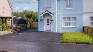 A two-story house with a white door and a small porch. - The Sperrin Getaway (Omagh)