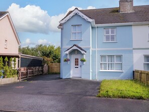 A two-story house with a white door and a small porch. - The Sperrin Getaway (Omagh)