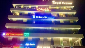A multi-story building with signage for 'Royal Crown' and 'Dwaraka'. - Rudanta Regency  (Phaltan)