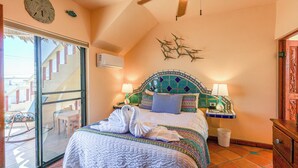 A hotel room with a bed, a ceiling fan, a window, and a door. - Campo Bello – Rooftop Terrace, Las Conchas (Puerto Peñasco)