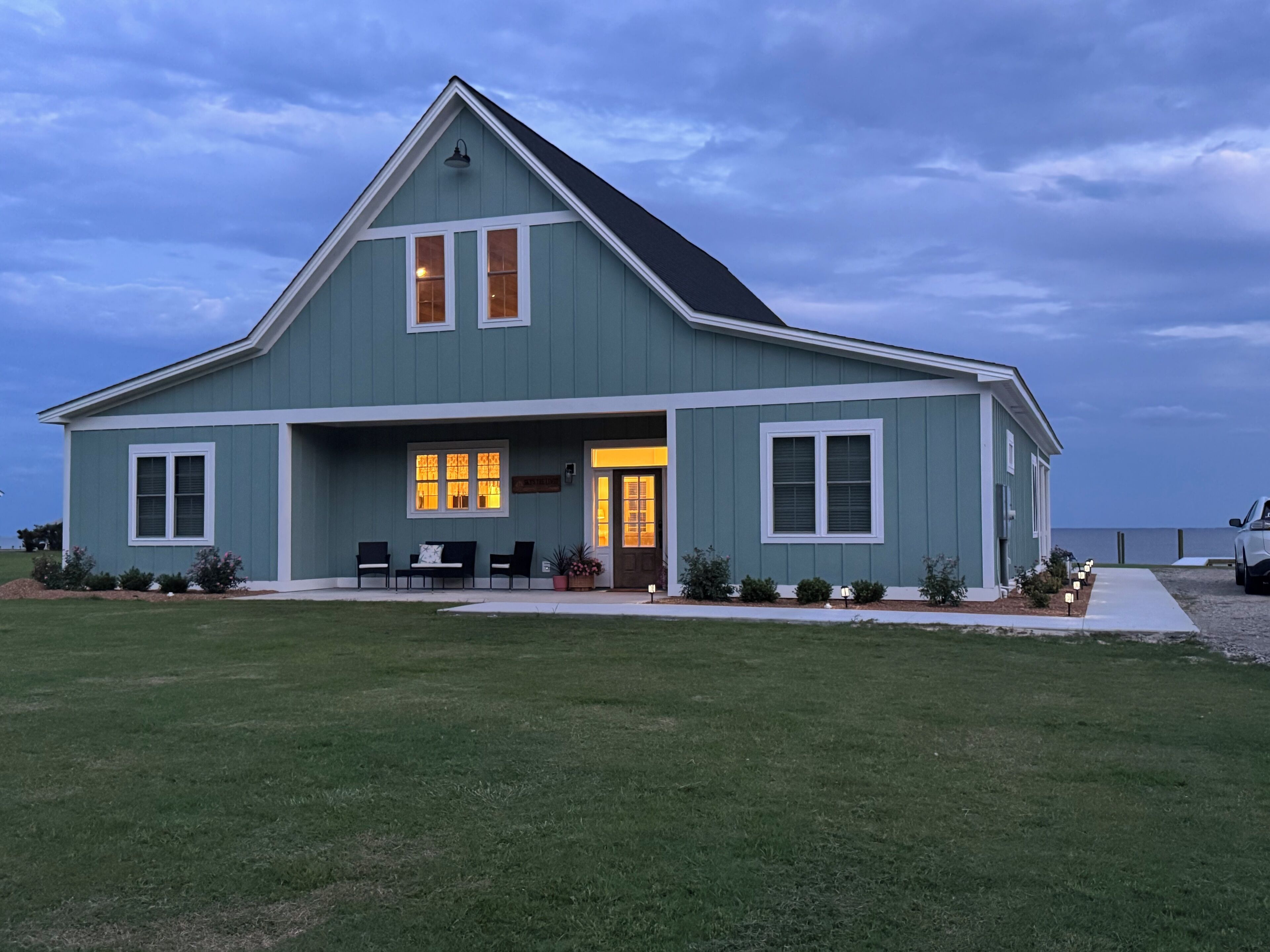 A two-story house with a front porch, a dining area, and a garage.