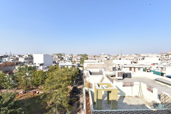 A residential area with multiple buildings, a playground, and a clear sky.