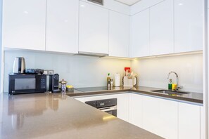 Deluxe Apartment, 1 King Bed, Balcony | Private kitchen | Highchair