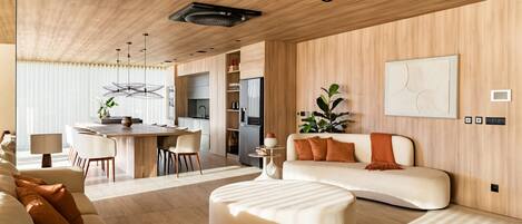 A modern living room with a sofa, ottoman, dining area, kitchen, and a large abstract painting on the wall.
