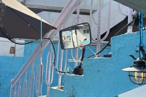 A vehicle's side mirror with a reflection of a building and a street. - JIN bok rotj (Uljin-gun)