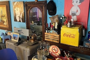 A room with a Coca-Cola cooler, a mirror, and various bottles and glasses on the counter. - JIN bok rotj (Uljin-gun)