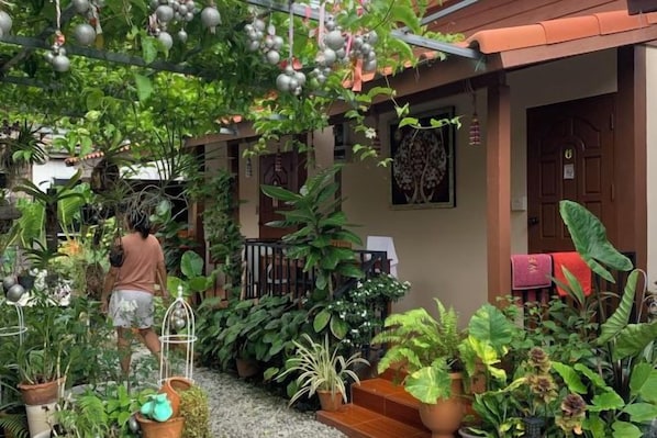 A garden area with potted plants and a person tending to them.