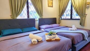 A hotel room with two beds, each with a headboard, and a window with a view.