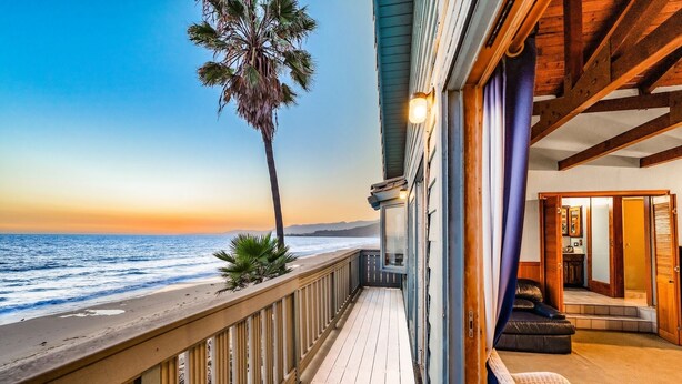 A wooden deck with a view of the ocean and a palm tree. - 25% Off Aug WkDays On The Sand, Perfect 4 Families (Ventura)