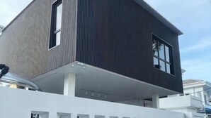 A modern two-story building with a dark exterior and white lower level. - 39 Haus (Bukit Mertajam)