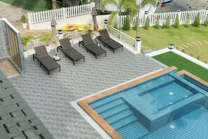 A rooftop pool area with lounge chairs and a swimming pool. - 2SIS'S Khanom Resotel (Khanom)