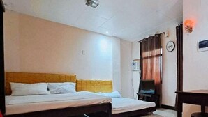 A room with two beds, a television, a clock, and a window with curtains. - RedDoorz @ JL Lodging House and Cafe Irosin (Irosin)