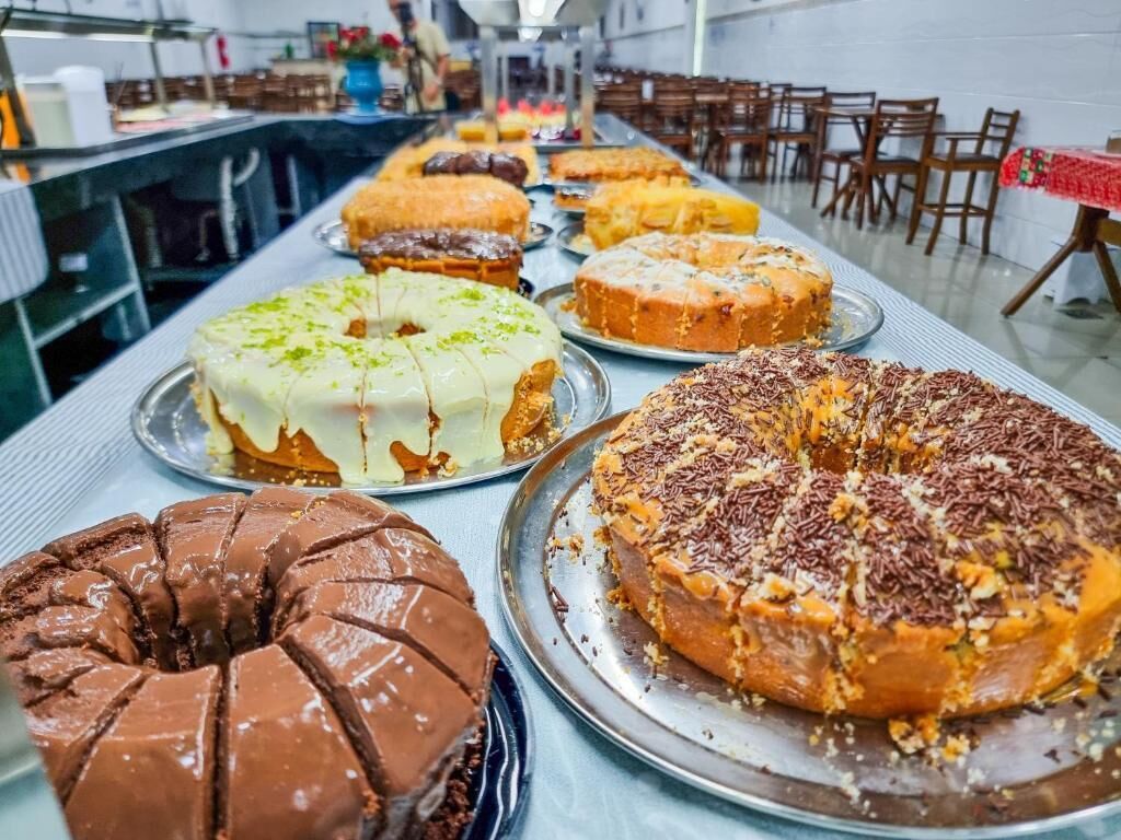A buffet table with various desserts.