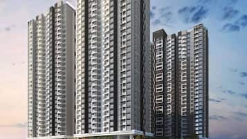 A high-rise residential building with multiple floors, balconies, and a modern architectural design.