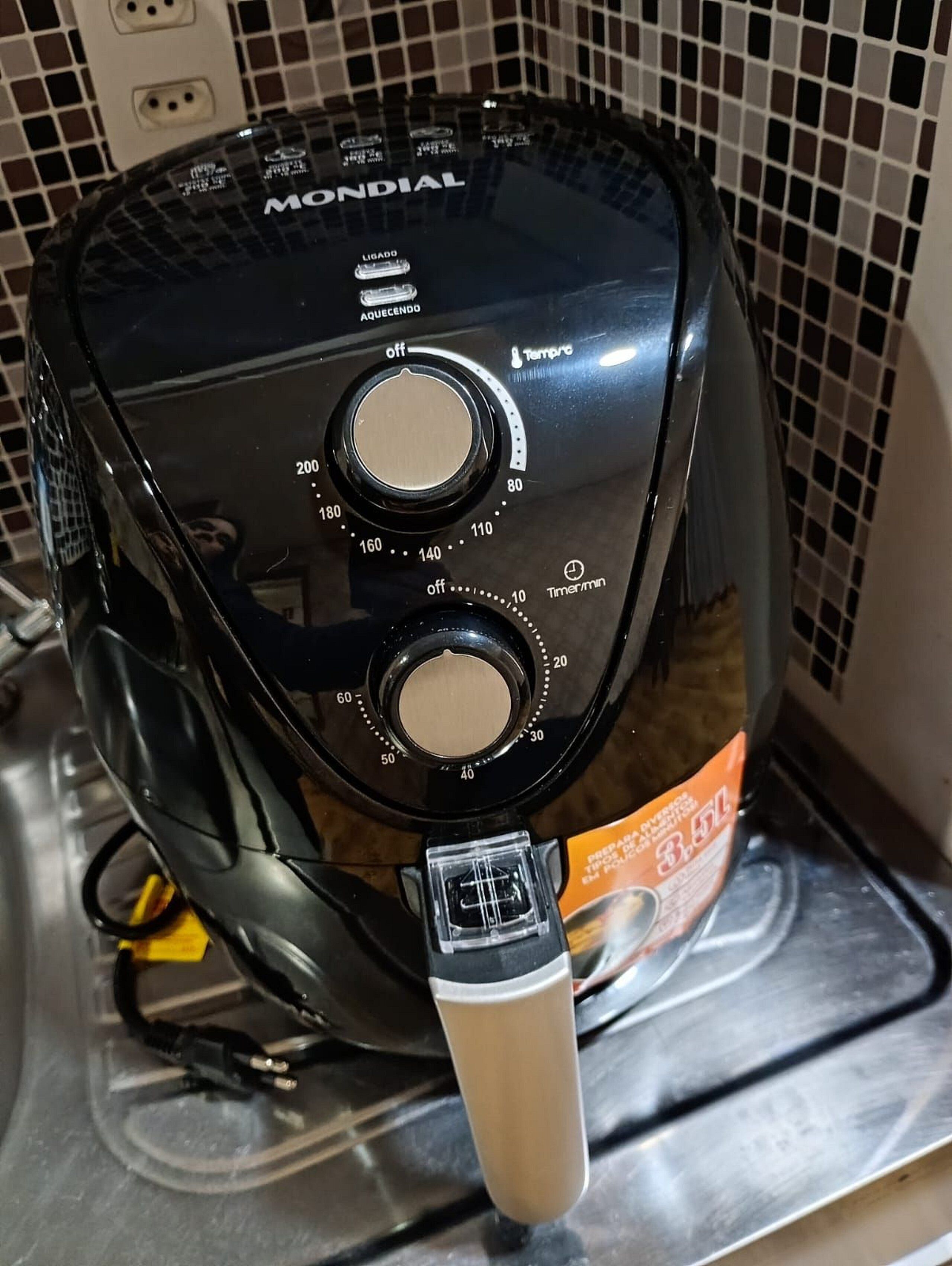 A kitchen with a black electric kettle and a bag of coffee.