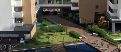 A modern hotel with a swimming pool, landscaped garden, and multiple balconies.