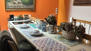 A kitchen with a long counter, various kitchenware, and two wall-mounted light fixtures. - Large, comfortable room, parking spaces, pets welcome, bicycle garage (Étaples)