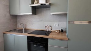 A modern kitchen with grey cabinets, a black dishwasher, and a stainless steel sink. - LA CASINA Panoramic apartment in the countryside very close to the village (Amelia)