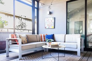 A modern living room with a sofa, coffee table, and artwork on the wall.