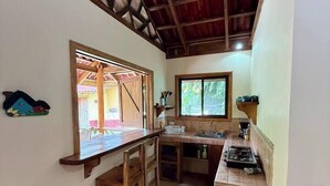 A compact kitchen with a wooden countertop, a sink, and a window. - 2 bed, 2 bath, full kitchen. With pool & parking. (Puerto Viejo de Talamanca)