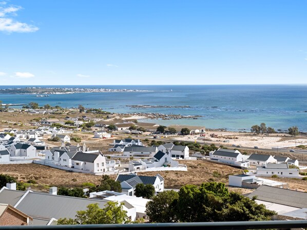A coastal residential area with white houses, a sandy beach, and the ocean in the background. - Blueberry Villa (St. Helena Bay)