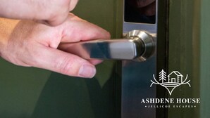 A hand using a numeric keypad on a door lock.