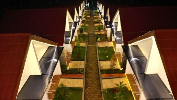 A symmetrical, multi-level hotel structure with a central pathway leading to the top.