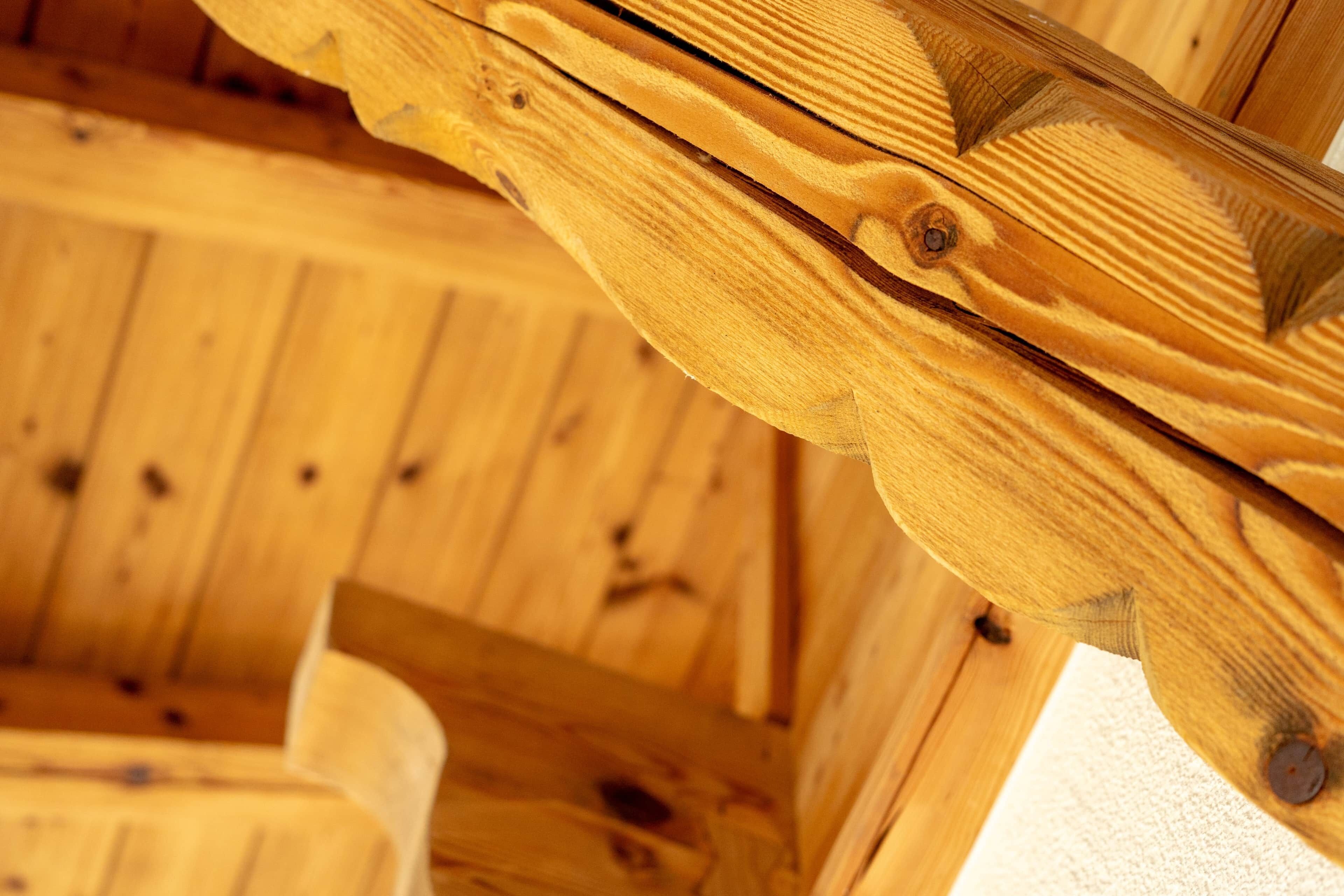 A close-up of wooden beams and a ceiling structure, likely part of a building's interior architecture.