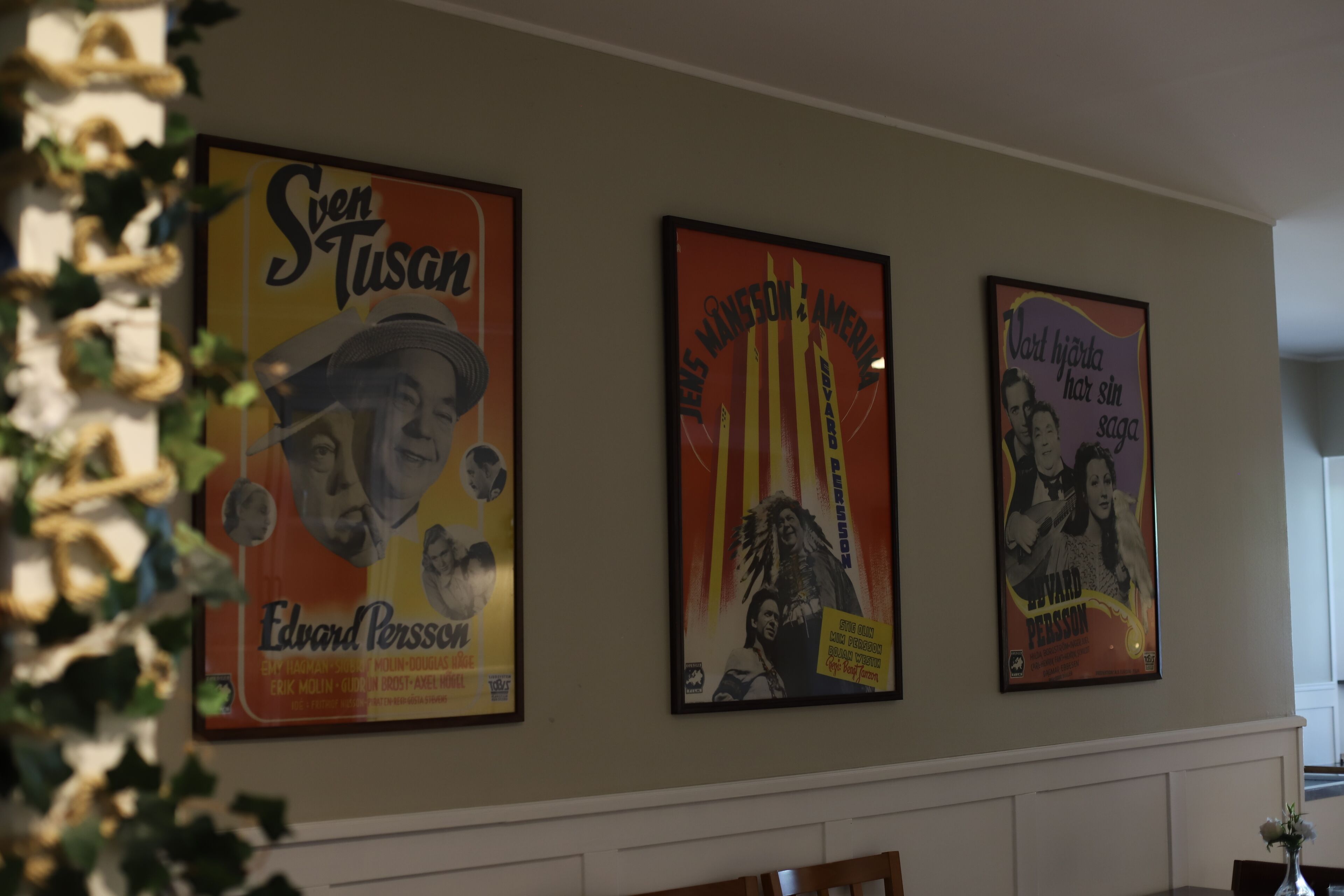 Three framed posters on a wall.