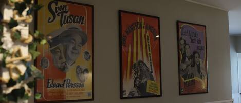 Three framed posters on a wall.
