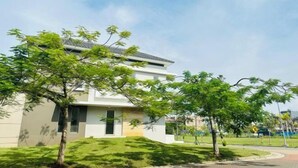 A modern building with a flat roof and a small front garden. - winner house (North Jakarta)