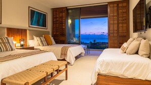 A hotel room with two beds, a bench, a painting, and a view of the ocean. - Condo Haramara Luxury Oceanview in TAU Punta Mita (Punta Mita)