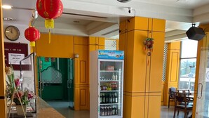 A hotel lobby with a reception desk, a beverage vending machine, and a check-in counter. - INTERTOWER HOTEL (Su-ngai Kolok)