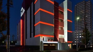 A modern hotel with a prominent 'LA LA' sign, multiple floors, and a red accent on the facade. - Hotel LALA kitashiga (Nagoya)