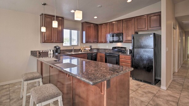 A modern kitchen with granite countertops, stainless steel appliances, and wooden cabinets. - 3 Mi to Beach & Boat Launch: Lake Havasu Home! (Lake Havasu City)
