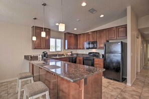 A modern kitchen with granite countertops, stainless steel appliances, and wooden cabinets. - 3 Mi to Beach & Boat Launch: Lake Havasu Home! (Lake Havasu City)