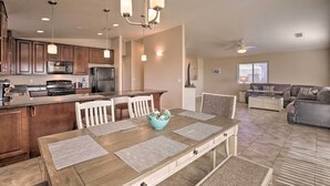 A modern kitchen with dark wood cabinets, a central island, and pendant lighting. - 3 Mi to Beach & Boat Launch: Lake Havasu Home! (Lake Havasu City)