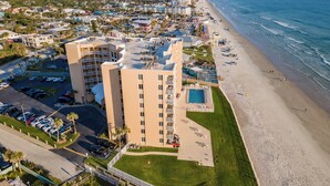 Un hotel moderno con piscina y acceso directo a la playa.