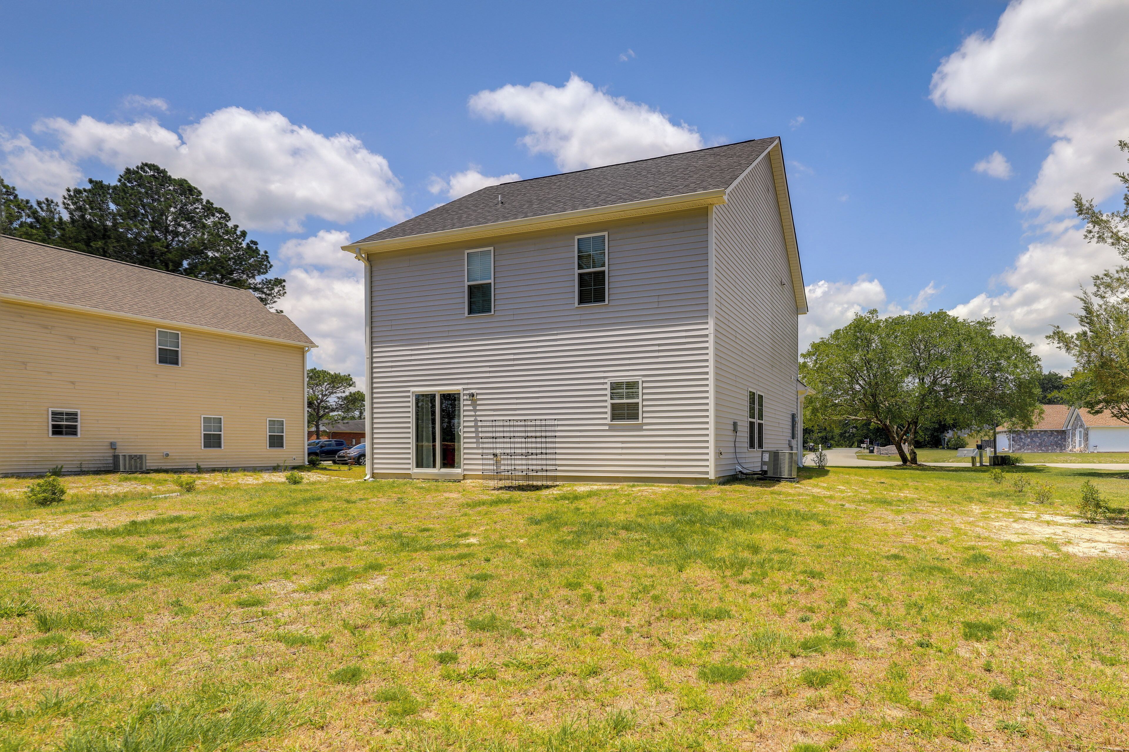 A two-story house with a front door and a small porch.