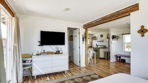 A bedroom with a bed, a TV, a dresser, and a window. - Boho Bungalow w/ Hot Tub: 16 Mi to Joshua Tree NP (Twentynine Palms)