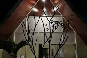 A building with a triangular roof and a large window. - KALININGRAT COTTAGE 2 (Pronojiwo)