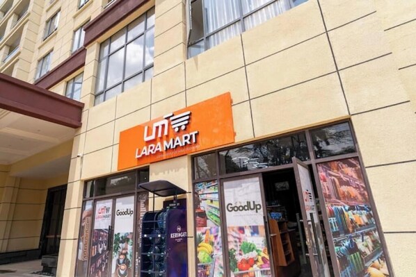 A Laramart store with a sign above the entrance, large windows displaying various products, and a visible GoodUp advertisement.