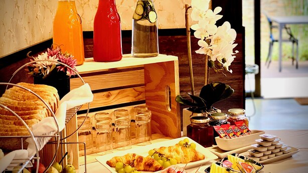 A breakfast buffet with various food items, drinks, and condiments. - Kgarebana Boutique Guesthouse (Sesakhile)